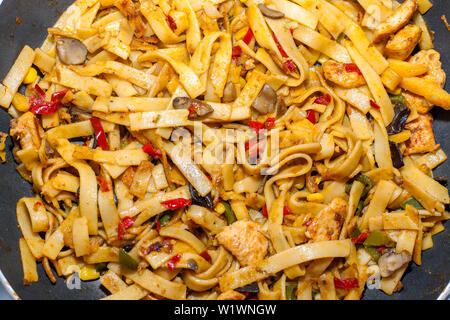 Bami Goreng is a pasta dish. Dish is made on a indonesian way with chicken brast and pasta. Stock Photo