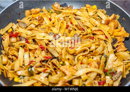 Bami Goreng is a pasta dish. Dish is made on a indonesian way with chicken brast and pasta. Stock Photo