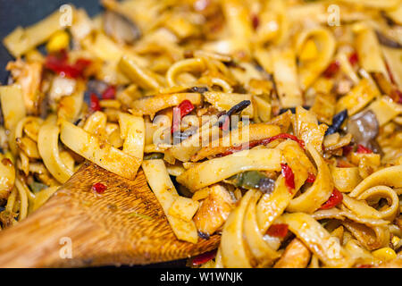 Bami Goreng is a pasta dish. Dish is made on a indonesian way with chicken brast and pasta. Stock Photo