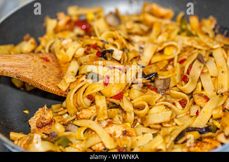 Bami Goreng is a pasta dish. Dish is made on a indonesian way with chicken brast and pasta. Stock Photo