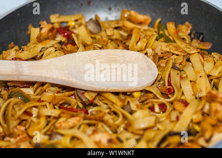 Bami Goreng is a pasta dish. Dish is made on a indonesian way with chicken brast and pasta. Stock Photo