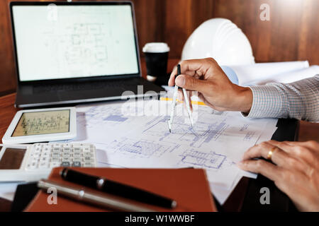 Real-estate concept, Two engineer and architect discussing blueprints data working and digital tablet on construction building project. Stock Photo