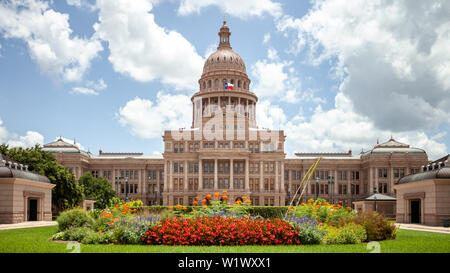 Texas State Capitol in Austin, Texas on a sunny summer day with colorful flowers in the front yard Stock Photo