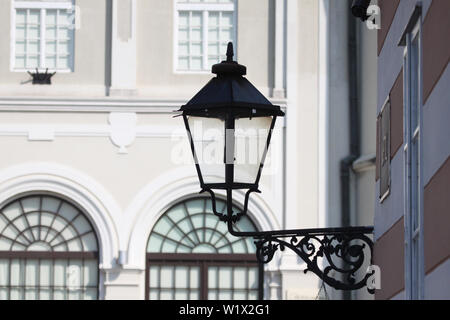 Ancient lantern on the facade of the restored building. Stock Photo