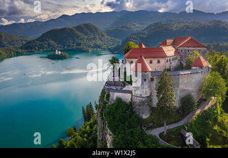 Bled, Slovenia - Aerial view of beautiful Bled Castle (Blejski Grad) with Pilgrimage Church of the Assumption of Maria on a small island and Julian Al Stock Photo