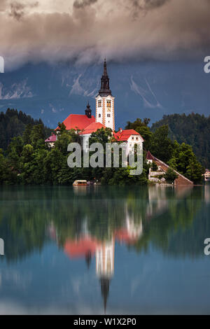 Lake Bled, Slovenia - Morning view of Lake Bled (Blejsko Jezero) with the Pilgrimage Church of the Assumption of Maria on a small island and Julian Al Stock Photo