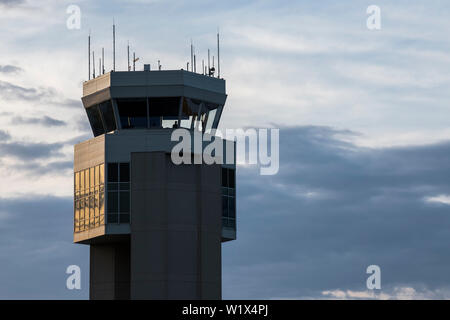 The sun slowly sets, its glow reflecting off the Dover Air Force Base air traffic control tower May 9, 2019, Del. Air traffic controllers are positioned in the tower to ensure every aircraft and vehicle on the airfield is taken care of, as well as every aircraft in flight within a radius of 10 to 15 miles. (U.S. Air Force photo by Senior Airman Christopher Quail) Stock Photo