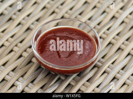 close up of Smoked red bbq sauce in glass bowl Stock Photo