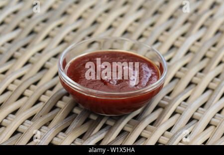 close up of Smoked red bbq sauce in glass bowl Stock Photo