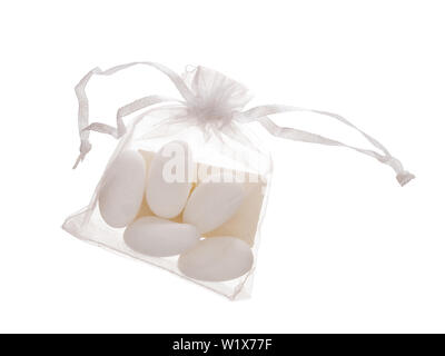 Bomboniere contents, 5 sugared almonds in bag with note, traditionally given as wedding favour, gift in Italy and called confetti. Isolated on white. Stock Photo