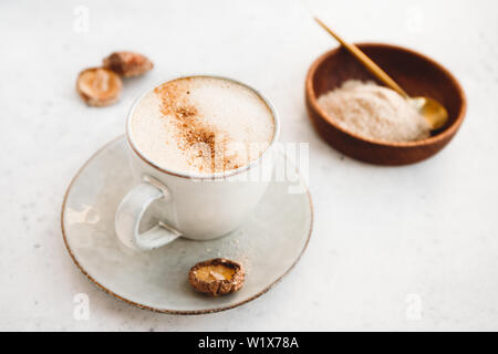 Mushroom latte with Shiitake powder and unsweetened coconut-almond blend milk. Healthy useful vegan drink. Stock Photo