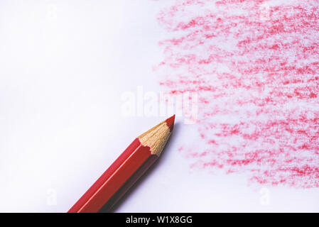 wooden crayon texture with cyan red drawings on white paper background Stock Photo