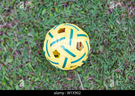 Sepak Takraw ball on green grass field / rattan ball sport outdoor Stock Photo