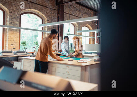 Working together. Three talented hard-working graphic designers working on the project together Stock Photo