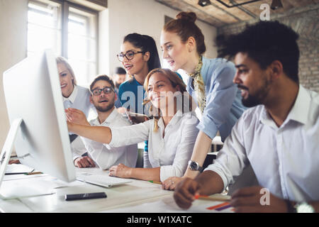 Group of business professionals having a meeting. Diverse group of designers smiling at the office. Stock Photo