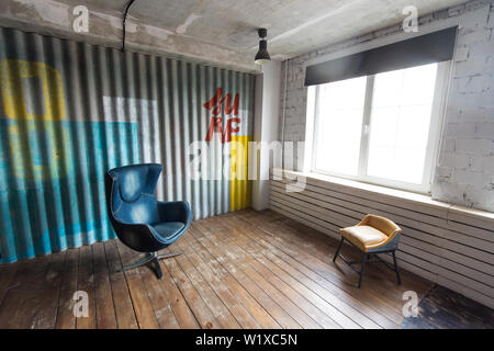Nizhniy Novgorod, Russia - March 24, 2017: Studio 2.8. Loft-style interior with two armchairs. Stock Photo