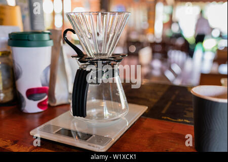 Measuring coffee drip with glass mug on counter bar Stock Photo