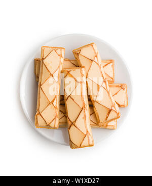 Sweet biscuits. Tasty dessert on plate isolated on white background. Stock Photo