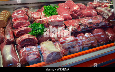Showcase with raw meat in butcher shop. Stock Photo