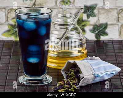 Honey sweetened blue butterfly pea flower (Clitoria ternatea) iced tea Stock Photo