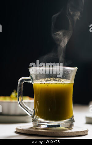 Hot matcha tea in transparent cups on the rustic table Stock Photo