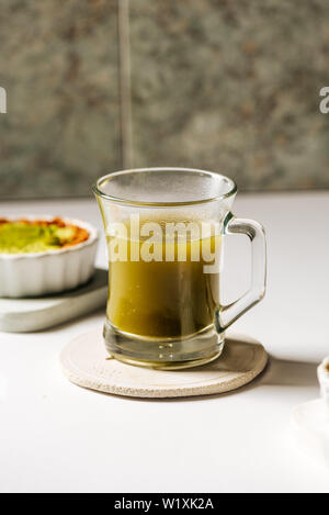 Hot matcha tea in transparent cups on the rustic table Stock Photo