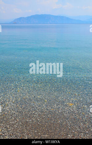 Sea landscape with pebbles and island in Turunc, Turunch Kumlubuk Mugla Stock Photo