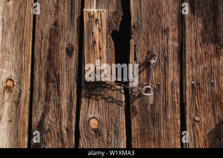Old wooden gates with black backdrop Stock Photo