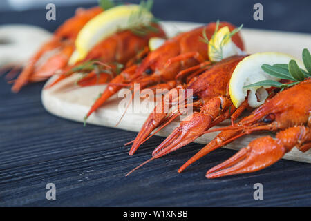Close-up of boiled crawfish with lemon and herb Stock Photo