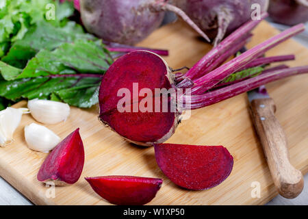 Red Beetroot with herbage green leaves on wooden background Stock Photo