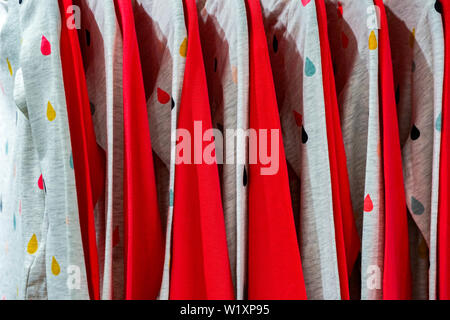 Variety sweaters brand name hang on to the hanger in the fashion cloth store in department store. Stock Photo