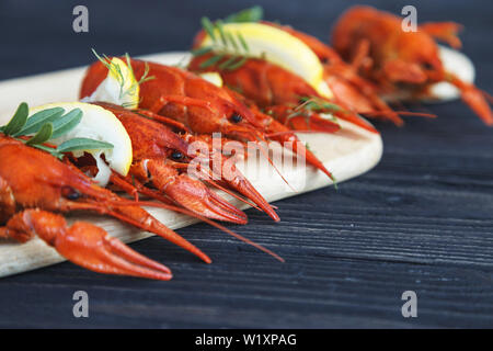 Close-up of boiled crawfish with lemon and herbs Stock Photo