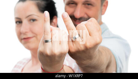 Closeup of man and woman couple presenting wedding rings on fingers isolated on white studio background Stock Photo