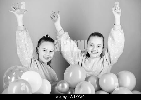 Having fun concept. Balloon theme party. Girls best friends near air balloons. Birthday party. Happiness and cheerful moments. Carefree childhood. Start this party. Sisters organize home party. Stock Photo