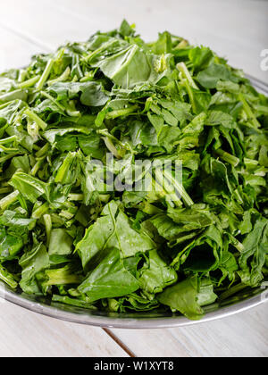 Chopped fresh spinach in bowl Stock Photo