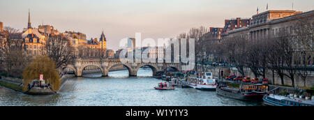 View of the Pont Neuf crossing the Seine River in Paris France with the late afternoon light in the month of February. Stock Photo