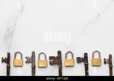 Vintage keys and padlocks overhead lay flat composition. Security concept Stock Photo