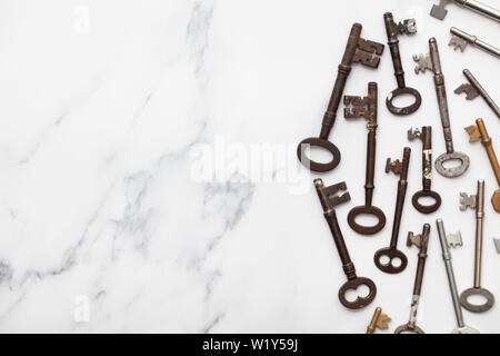 Vintage old fashioned keys on a marble background with copy space Stock Photo