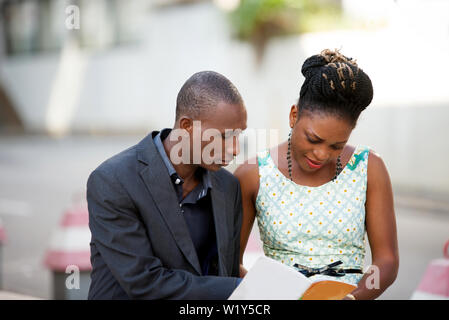 portrait of young colleagues working together sitting outside. Stock Photo