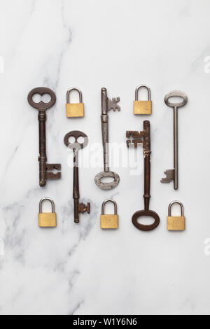 Vintage keys and padlocks overhead lay flat composition. Security concept Stock Photo