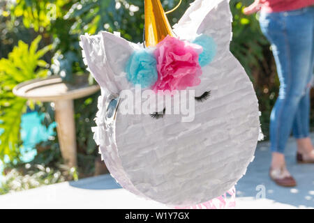 A close up view of a unicorn pinata at a kids birthday party ready and waiting Stock Photo