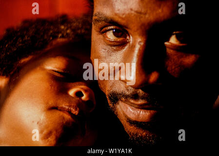 London, 1990. Portrait of boxer Nigel Benn with his son Dominic. Nicknamed The Dark Destroyer, he held the WBO middleweight title in 1990, and the WBC Stock Photo