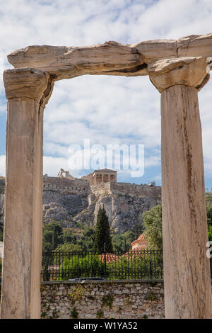 A few columns still stand at Hadrians Library and frame the Acropolis above in Athens, Greece. Stock Photo