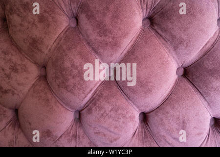 The structure of purple velor fabric. Modern upholstered velvet furniture. Creative vintage background. Quilted fabric Stock Photo
