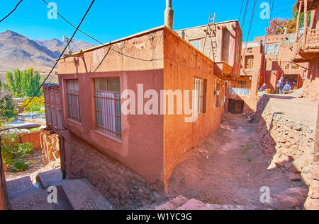 The village is situated on the mountain slope, it has many steep descents with staircases and terrace buildings of red adobe, Abyaneh, Iran. Stock Photo