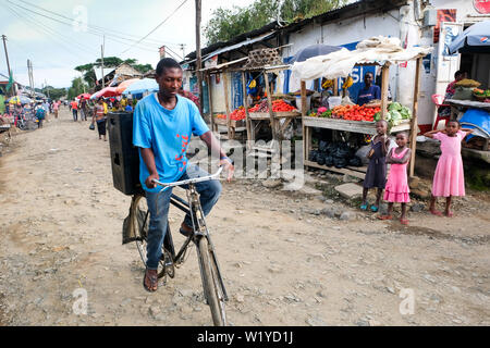 Steet vendor on a bicycle in Mbeya, Tanzania, Africa   ---   Obst- und Gemüsestand in Mbeya,Tansania. Stock Photo