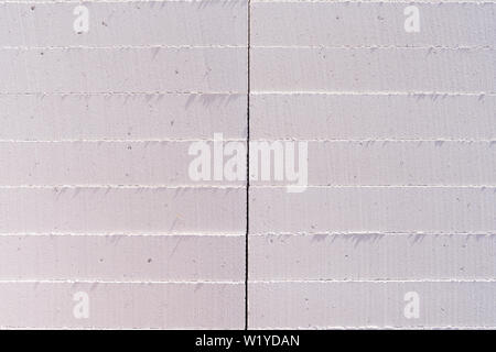 The blocks of foam, neatly folded on the construction site. Creative vintage background from gray concrete Stock Photo