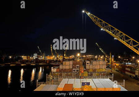 montevides, uruguay - 2014.01.31:  german containership msc alessia  imo no 9225653) discharging containers during nighttime at montevideo port Stock Photo