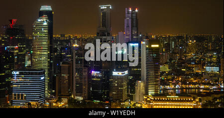 Towers and skyscrapers of downtown Singapore lit up at night. Stock Photo