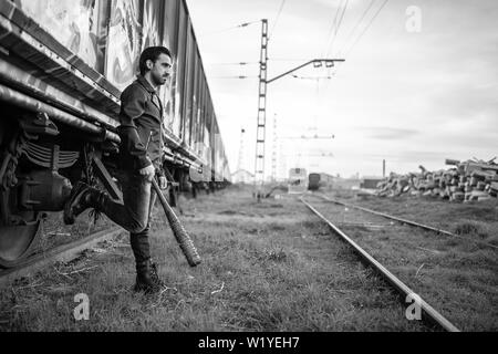 man in leather jacket and baseball bat Stock Photo